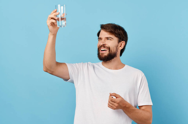 man in white t-shirt drinking water isolated background - Φωτογραφία, εικόνα