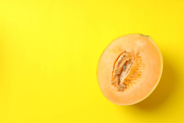 Half of juicy melon on yellow background - Zdjęcie, obraz