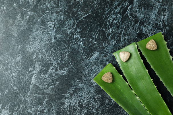 Concept of herb pills with aloe on black smokey background - Photo, Image