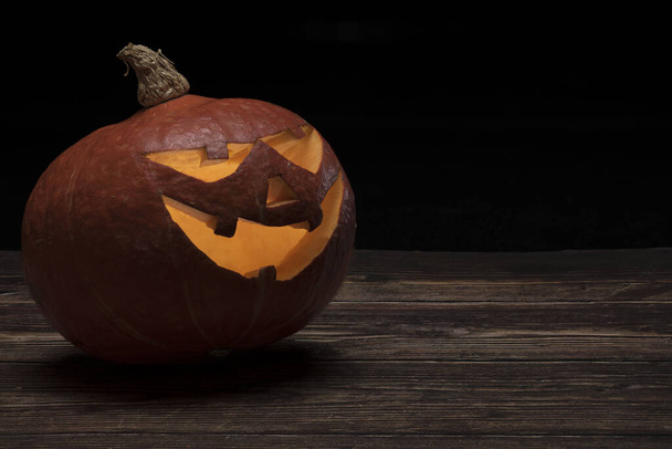 illuminated halloween pumpkin jack o lantern in front of black background - Φωτογραφία, εικόνα