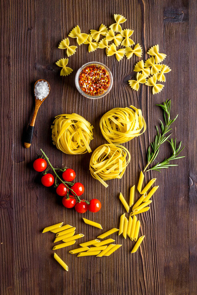 Fettuccine pasta with ingredients - tomatoes olive oil and herbs - Photo, image
