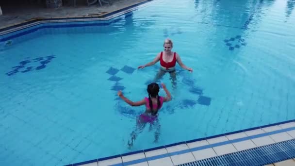 Mooie vrouw met haar dochter in zwembad - Video