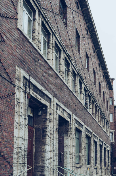 perspective view of old brick building on gloomy day - Φωτογραφία, εικόνα