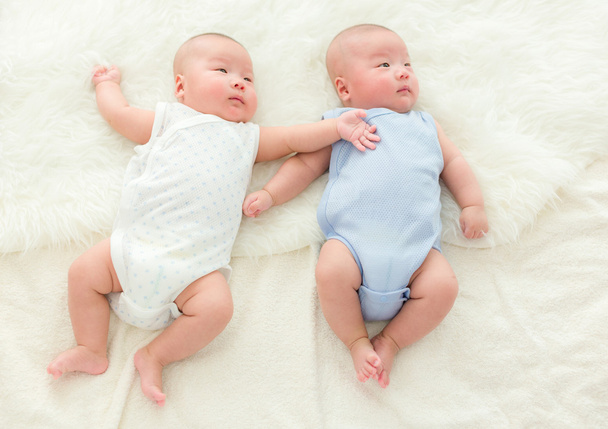 Twins baby lying on bed - Photo, Image