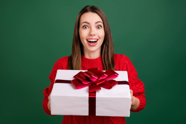 Photo of young excited girl happy positive smile get gift box celebration holiday isolated over green color background - Foto, afbeelding