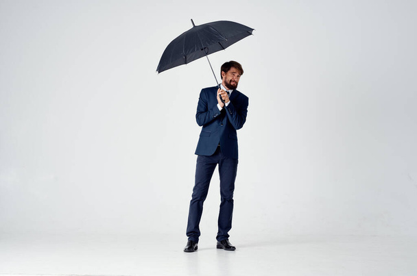 business man in a suit manager office work umbrella in hand - 写真・画像