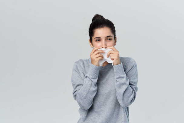 brunette wipes her nose with a handkerchief runny nose unhealthy look - Fotoğraf, Görsel