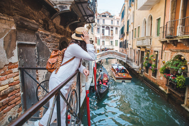 woman looking at canal with gandola - Foto, Imagen