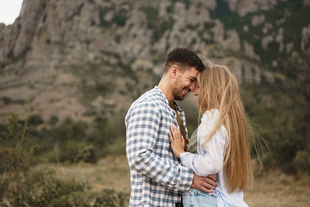 Happy loving couple hiking and hugging in mountains - Photo, Image