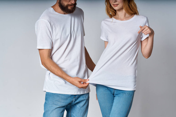 man and woman in white t-shirts cropped view mocap advertisement - Fotó, kép