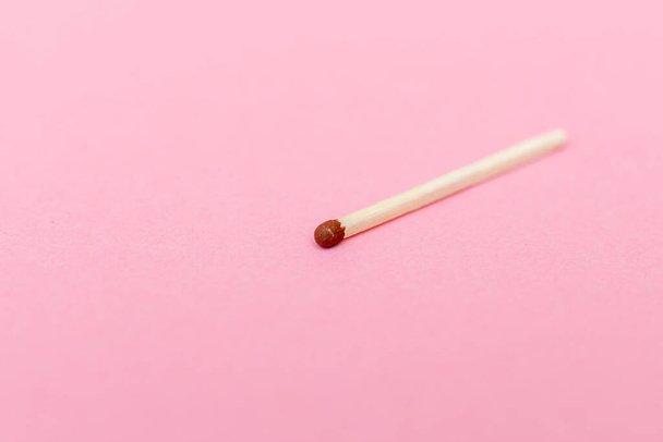 Closeup match on a pink background with clipping path.matchstick flat lay,copy space,selective focus.Studio shot. - Φωτογραφία, εικόνα