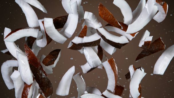 Freeze motion of flying coconuts pieces - 写真・画像