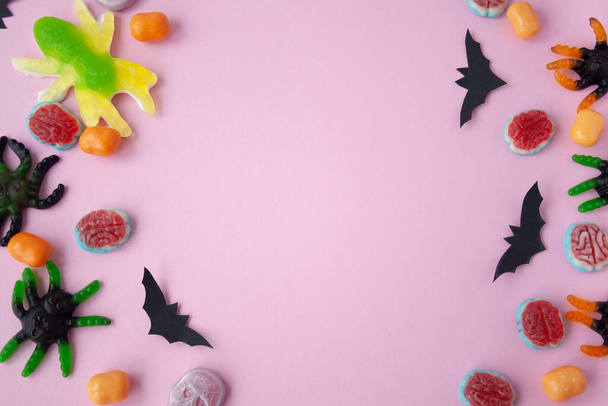 Halloween candy on pink background - Фото, изображение
