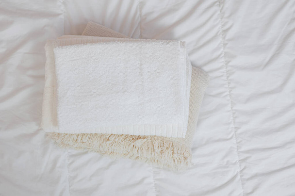 Heimtextilien Flatlay. Ein Stapel Handtücher liegt auf einem weißen Bett - Foto, Bild