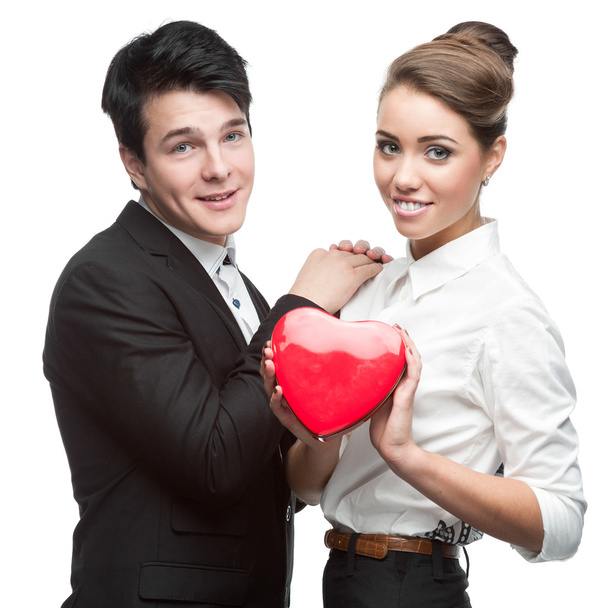 cheerful young business couple holding red heart - Photo, image
