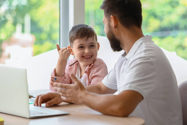 Kleiner Junge mit seinem Vater beim Unterricht zu Hause - Foto, Bild