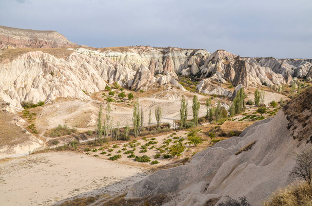 Unique colorful sandstone rock formations in the Rose Valley. Central Anatolia, Cappadocia, Turkey - Photo, Image