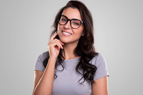 Cheerful woman in eyeglasses looking at camera - Fotó, kép