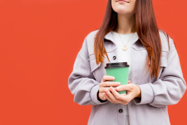 Young woman holding in hand coffee glass. - Фото, зображення