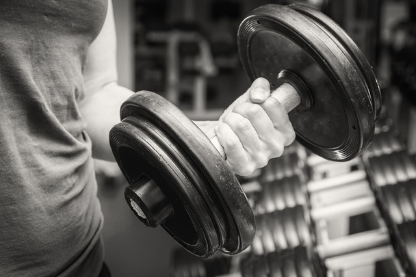 Hand holding a dumbbell. - Photo, Image