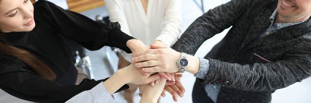 Group of people putting their hands together in office closeup - Photo, Image