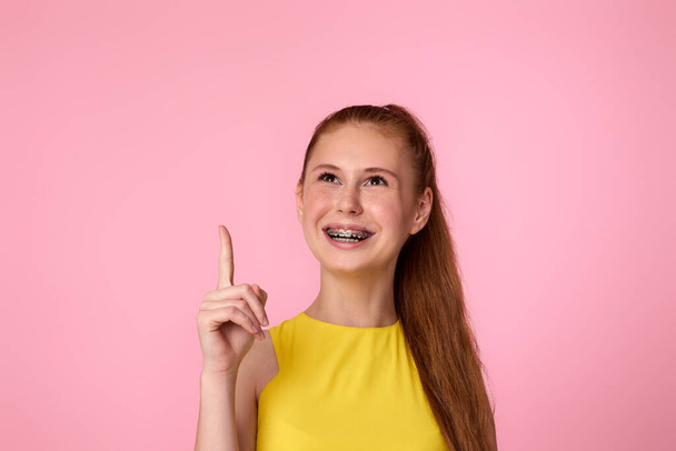 Happy excited blonde woman indicating finger empty space - Photo, image