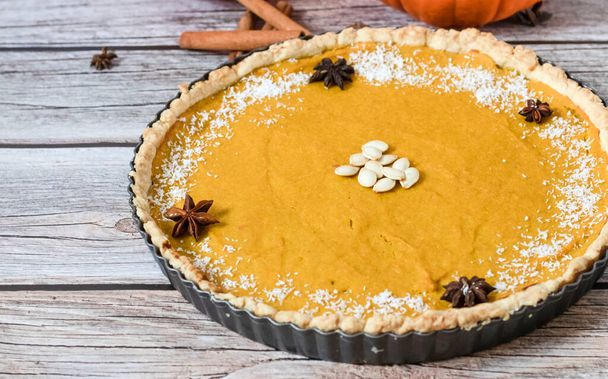 Delicious homemade American pumpkin pie. on a gray and woody background. - Photo, Image