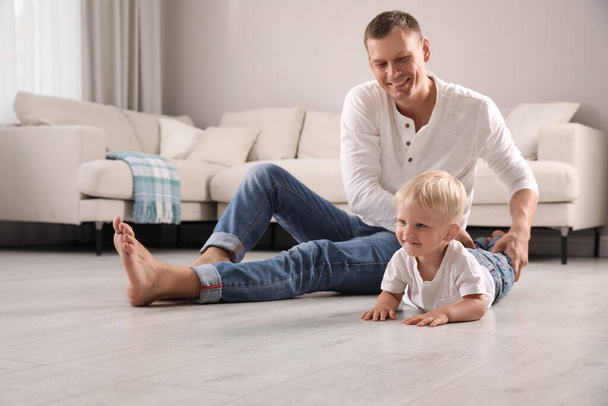Father with his cute little son in living room - Фото, зображення