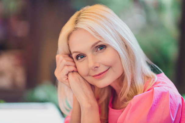 Photo portrait elder woman beautiful charming with blonde hair in pink clothes smiling dreamy - Photo, Image