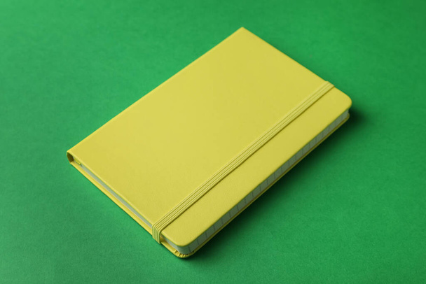New stylish planner with hard cover on green background - Foto, Imagem