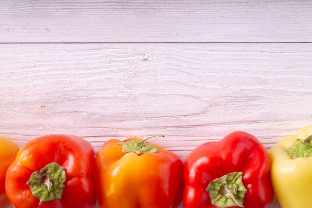 fresh red and yellow peppers on wooden background - Fotoğraf, Görsel