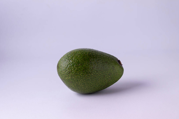 avocado on a purple background - Zdjęcie, obraz