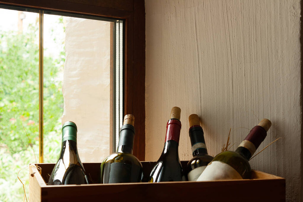 red wine in a row on a wooden table - Photo, Image