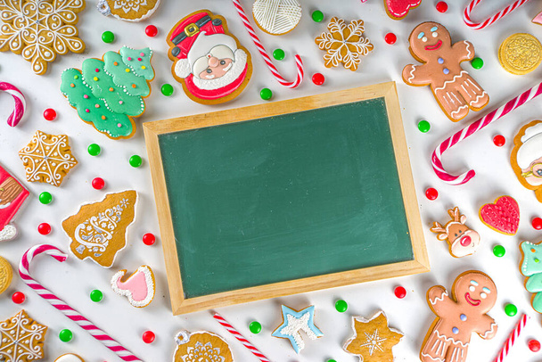 Vánoční cukroví. Různé slavnostní vánoční a novoroční sladkosti, tradiční cukroví a sušenky. Flatlay s cukrovou třtinou cukroví, perník, sladkosti, jednoduchý vzor horní pohled - Fotografie, Obrázek