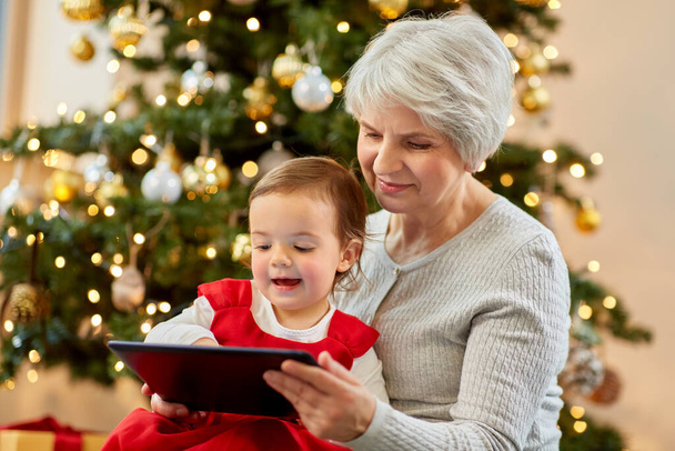 grandmother and baby girl with christmas gifts - 写真・画像