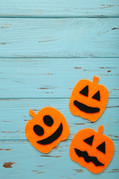 Halloween composition with pumpkins on blue background. Top view - Fotó, kép