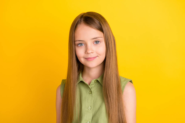 Photo of nice blond small girl wear khaki blouse isolated on yellow color background - Valokuva, kuva