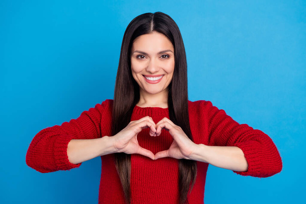 Portrait of attractive cheerful woman showing heart sign health care isolated over bright blue color background - Foto, afbeelding