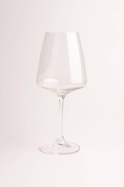 Empty transparent wine glass in ther light background. Silhouette of a glass goblet for a wine drink.  - Fotografie, Obrázek