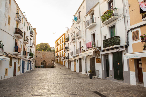 The architecture of the island of Ibiza. A charming empty white street in the old town of Eivissa.  - Zdjęcie, obraz