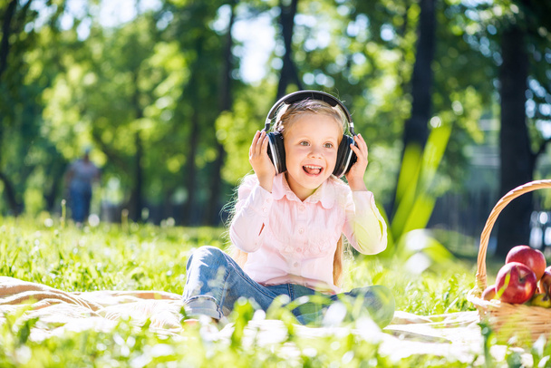 Girl in summer park listening music - Photo, Image