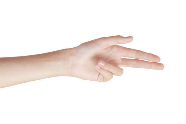 όμορφη γυναίκα χέρι σε ένα λευκό φόντο χειρονομία με δύο δάχτυλα στο πλάι. απομόνωση - Φωτογραφία, εικόνα