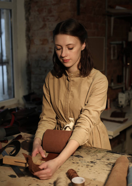 Lifestyle, freelance and home business concept: young woman works in a bag making studio - Photo, image
