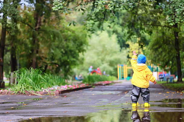 yellow raincoat boy look, autumn seasonal walk in the park - Фото, изображение