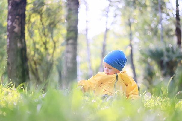 child flowers raincoat walk, seasonal spring autumn kid in waterproof clothes - Foto, immagini