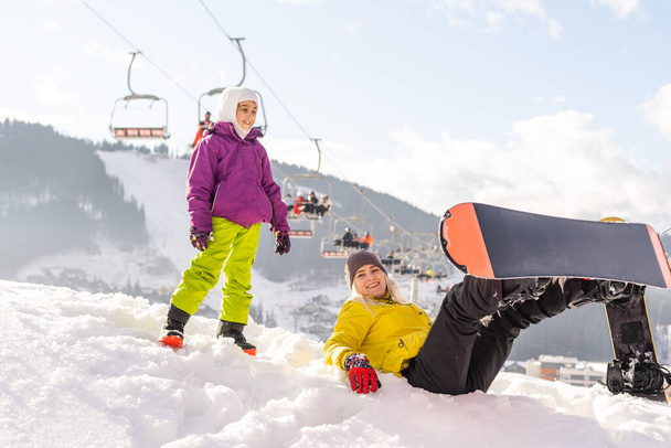 family with snowboards at winter resort - Photo, Image