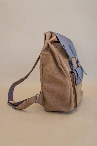 Canvas backpack isolated on beige background. Unisex bag - Photo, Image