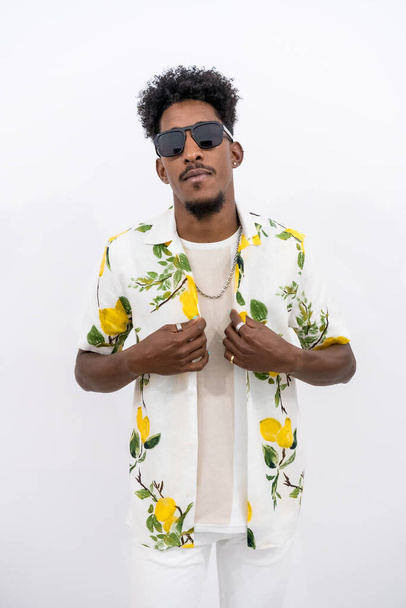 A young Cuban with a floral shirt and sunglasses on a white background - Φωτογραφία, εικόνα