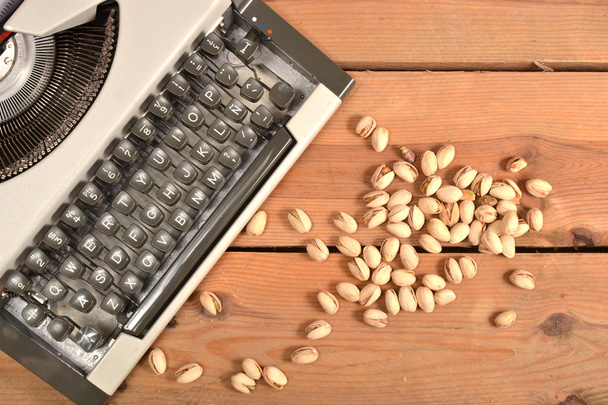 Typewriter and pistachios - Photo, Image