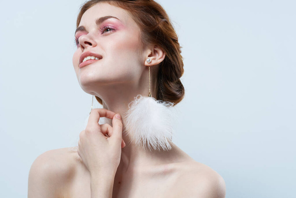 cheerful woman bare shoulders fluffy earrings studio cropped view - Photo, Image